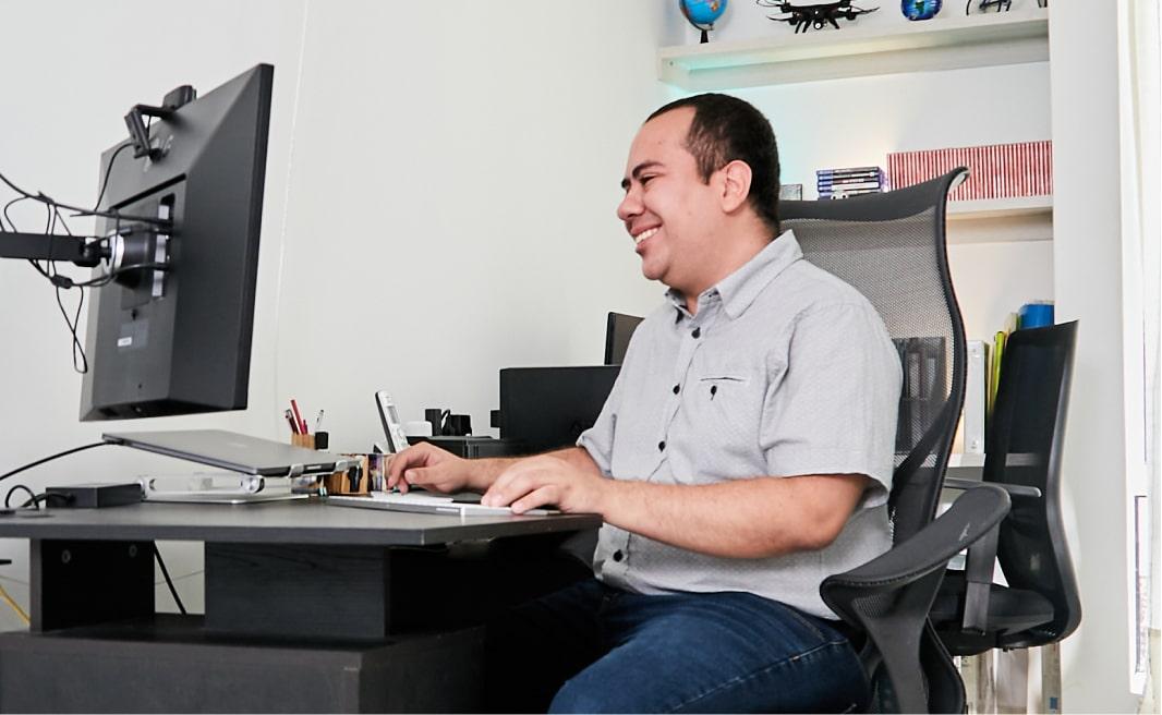 Tech Lead Backend Software Engineer Cesar Charria working on his desktop computer