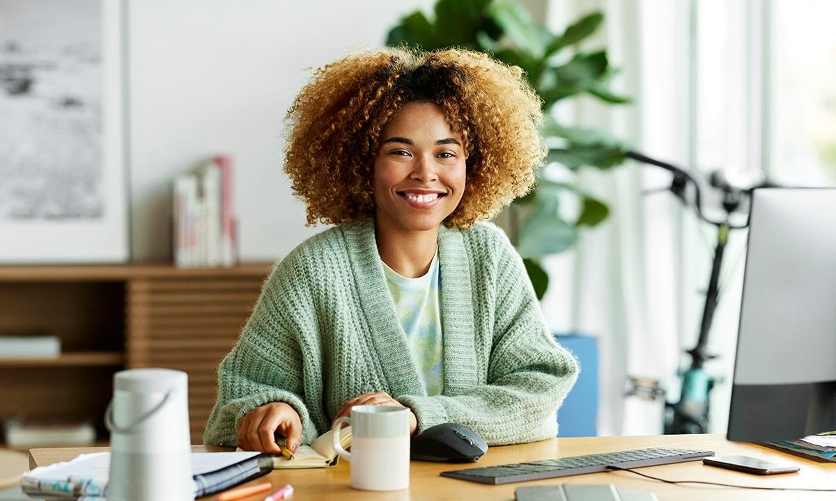 Female engineer smiling as she works full-time, fully-remote from home